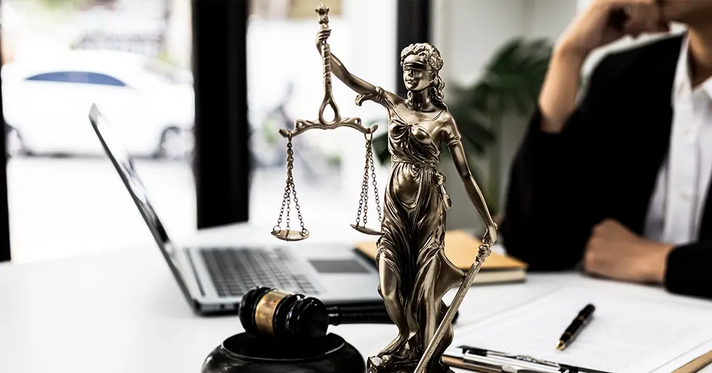 Gender-based honorifics are no longer required when female counsel introduces themselves. On top of the table shows Themis who is the goddess of justice and the hammer of justice.